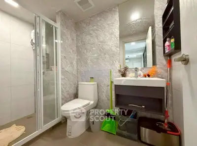 Modern bathroom with sleek fixtures and glass shower enclosure