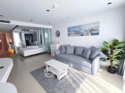 Modern open-plan living room with cozy sofa and stylish decor