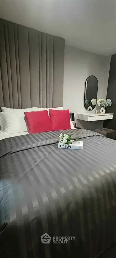 Elegant bedroom with modern decor, featuring a stylish bed and chic wall mirror, perfect for relaxation.
