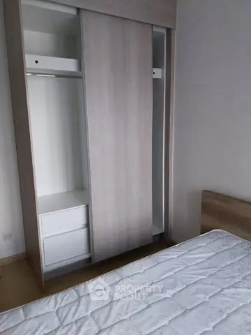 Modern bedroom with sleek wardrobe and comfortable bed