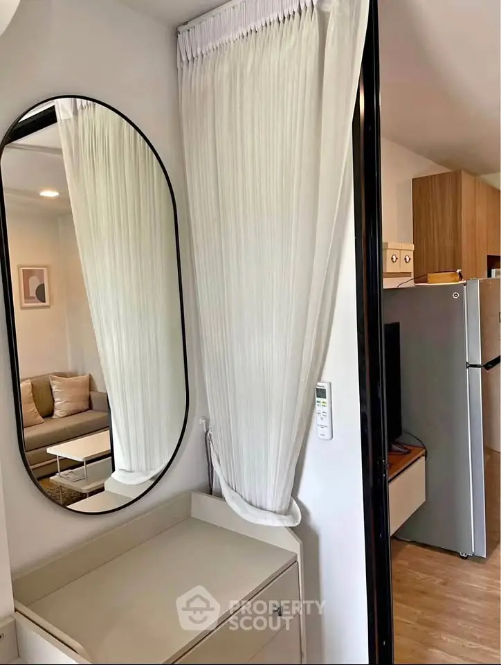 Modern apartment interior with stylish living room and kitchen area, featuring elegant decor and contemporary furniture.