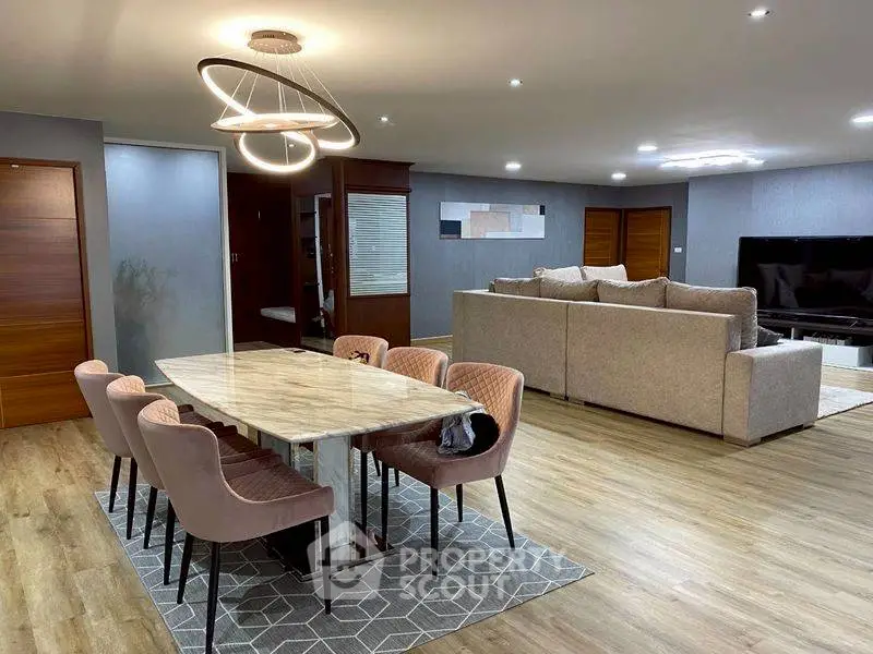 Spacious modern living room with elegant dining area and stylish lighting