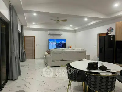 Spacious modern living room with elegant furniture and open layout, perfect for family gatherings.