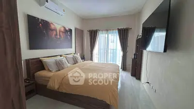 Spacious bedroom with modern decor and large window for natural light