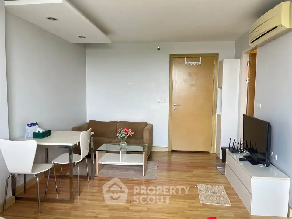 Modern living room with sleek furniture and wooden flooring in a cozy apartment.