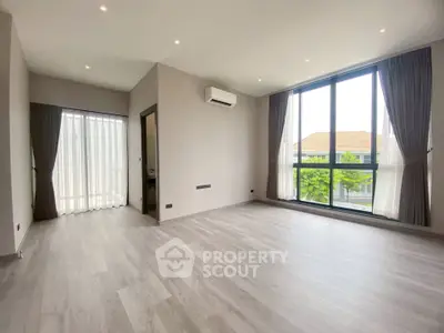 Spacious modern living room with large windows and sleek flooring