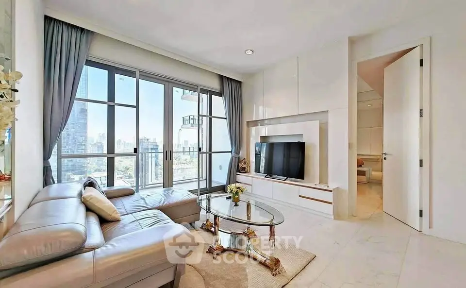 Luxurious living room with city view, elegant furnishings, and natural light in modern apartment.