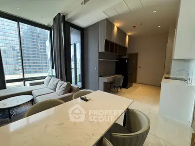 Luxurious modern living room with open kitchen and stunning city view
