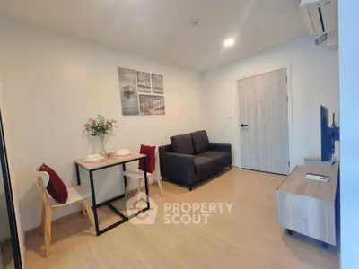 Modern living room with cozy seating and stylish decor in a contemporary apartment.