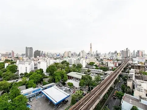 Stunning cityscape view with lush greenery and urban skyline, perfect for real estate investment.