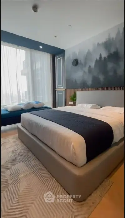 Serene bedroom with a stylish mural wall, modern furnishings, and abundant natural light filtering through sheer curtains, creating a tranquil urban oasis.