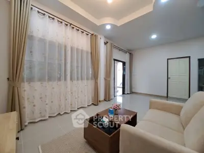 Spacious living room with elegant curtains and cozy seating area