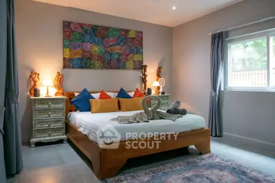 Charming bedroom with artistic decor and cozy ambiance, featuring a large bed and vibrant wall art.