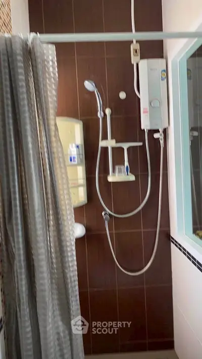 Modern bathroom with shower and water heater in stylish apartment.