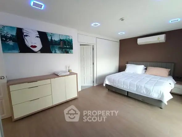 Spacious modern bedroom with stylish decor and air conditioning