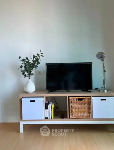 Modern living room with stylish TV stand and decor, perfect for cozy entertainment.