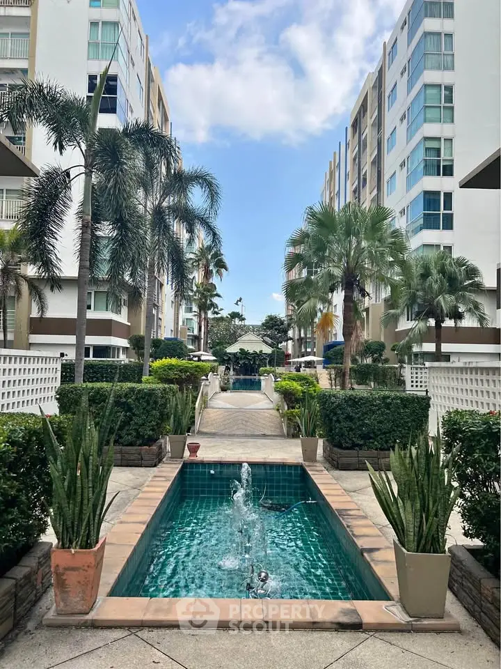 Stunning apartment complex with lush gardens and elegant water features.
