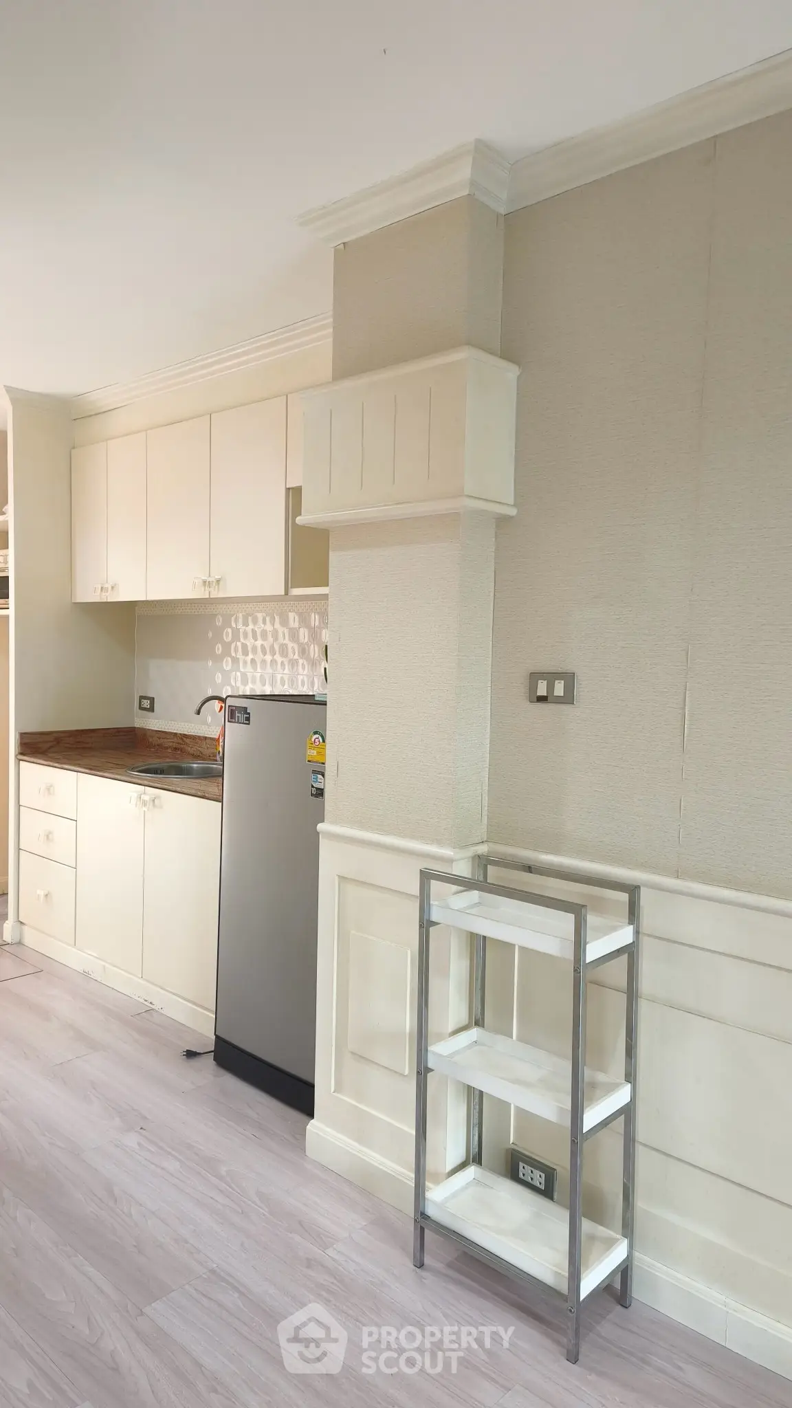 Modern kitchen with sleek cabinetry and stainless steel fridge in a bright, open layout.
