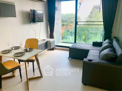 Modern living room with sleek furniture and large window view