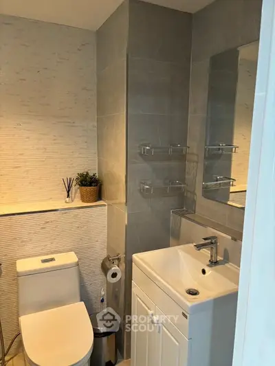 Modern bathroom with sleek fixtures and stylish gray tiles