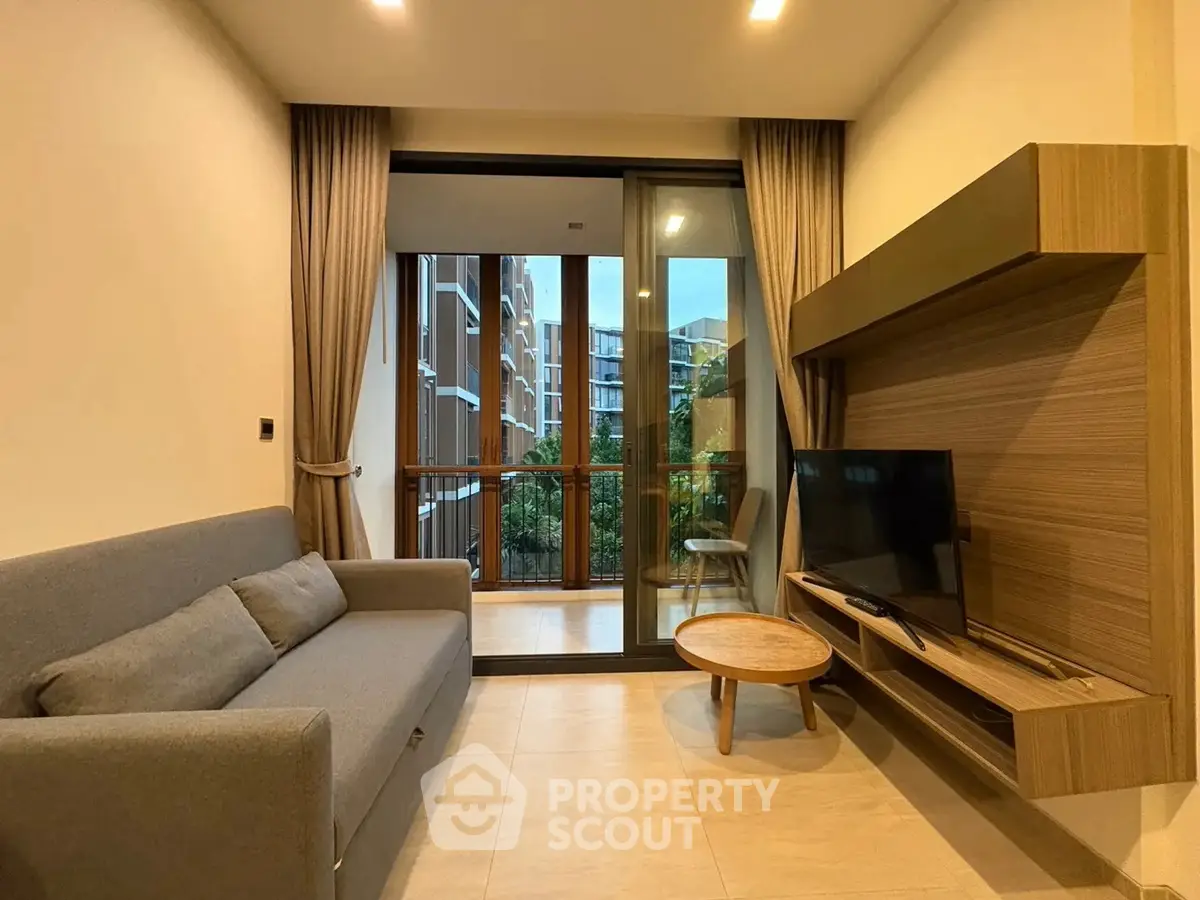 Modern living room with sleek furniture and balcony view in contemporary apartment.