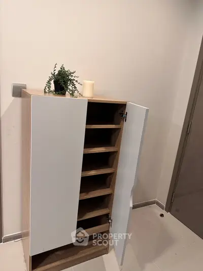 Modern storage cabinet with open shelves in minimalist interior design.