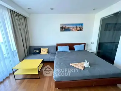 Modern bedroom with cozy seating area and stylish decor