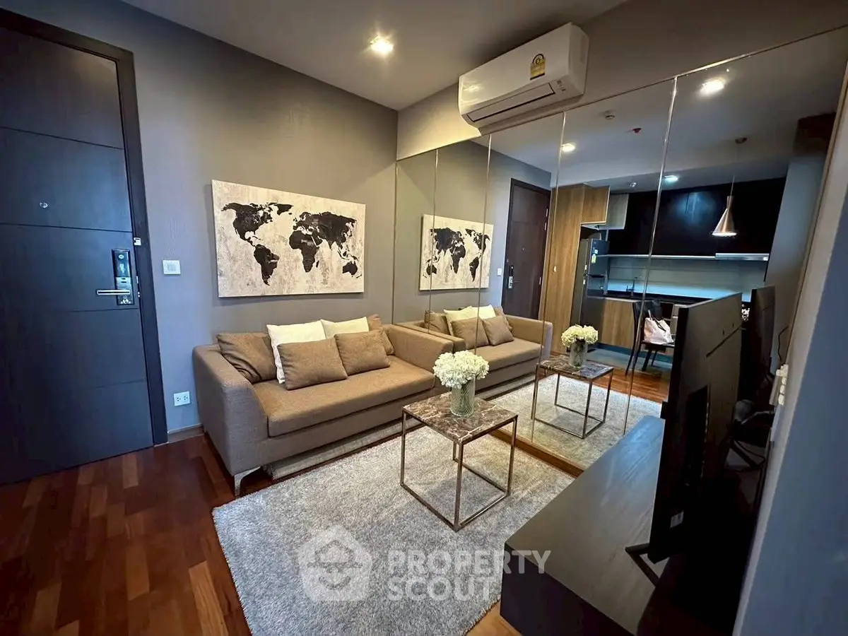 Modern living room with stylish decor and open kitchen layout in a contemporary apartment.