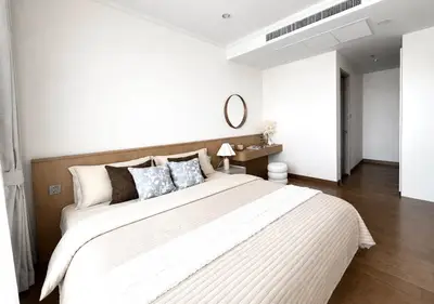 Elegant bedroom with modern decor and cozy bedding in a stylish apartment.
