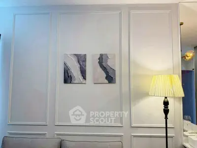 Elegant living room with modern wall art and stylish floor lamp