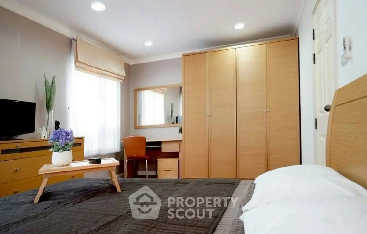 Spacious bedroom with modern furniture and natural light