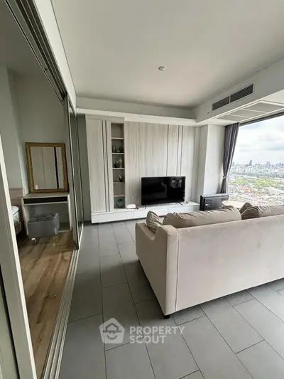 Modern living room with city view, featuring sleek furniture and large windows.