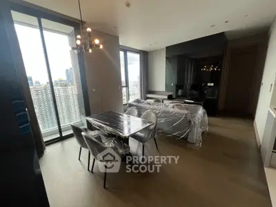 Modern living room with city view, stylish dining area, and elegant lighting.