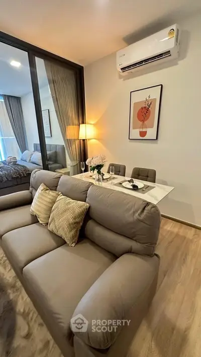 Modern living room with cozy sofa and dining area in stylish apartment
