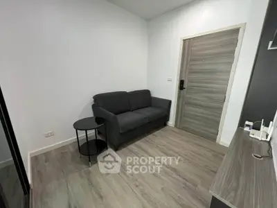 Modern living room with sleek gray sofa and stylish wooden flooring