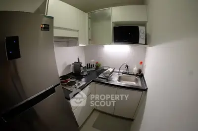 Compact modern kitchen with stainless steel appliances and sleek cabinetry