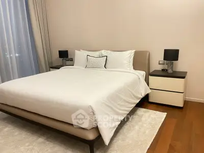 Elegant bedroom with modern decor and cozy ambiance, featuring a comfortable bed and stylish bedside tables.