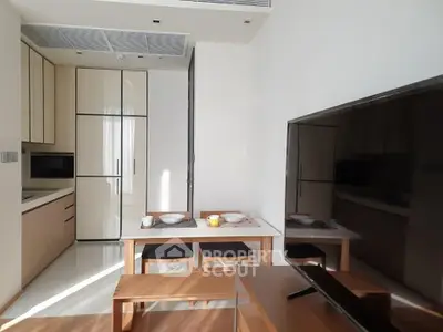Modern kitchen with dining area and sleek appliances in a stylish apartment