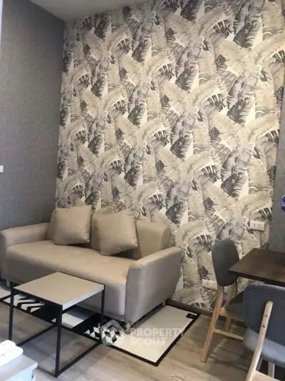 Stylish living room with modern wallpaper and cozy furniture in a contemporary apartment.