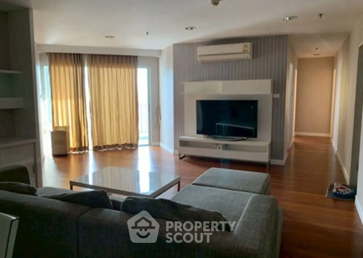 Spacious living room with modern furniture and large windows for natural light.