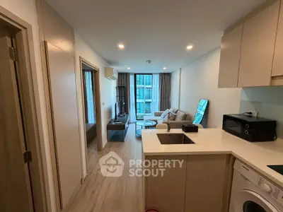 Modern open-plan apartment with cozy living area and compact kitchen