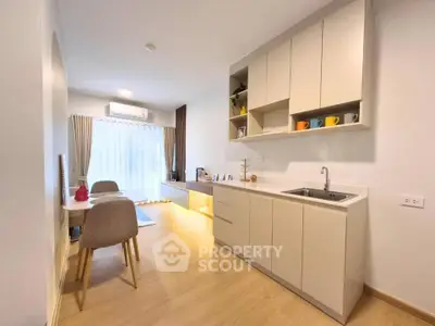 Modern open-layout kitchen and dining area with natural light and stylish decor.