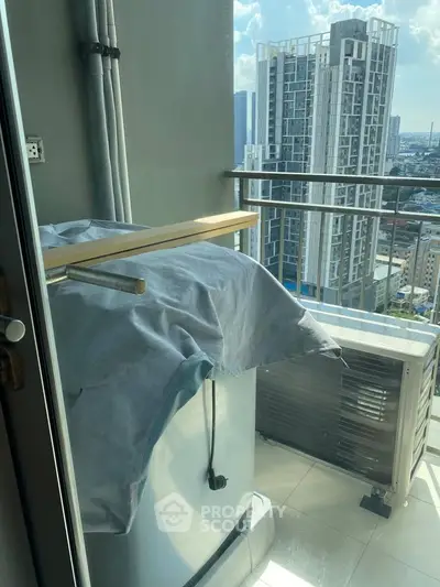 High-rise balcony with city view and air conditioning unit, perfect for urban living.