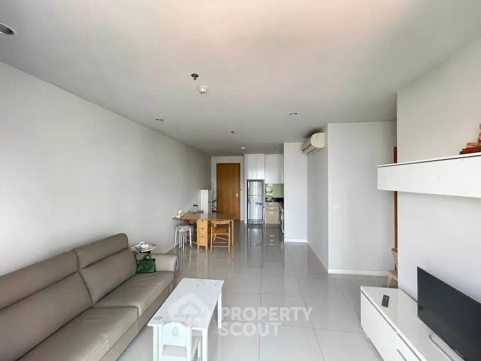 Spacious modern living room with sleek furniture and open layout, perfect for contemporary living.