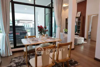 Elegant dining area with large windows and stylish decor in modern home