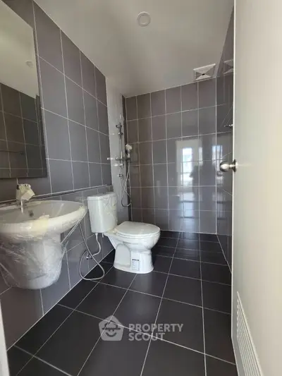 Modern bathroom with sleek gray tiles and contemporary fixtures
