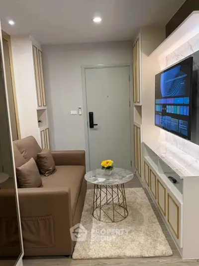 Modern living room with cozy sofa, marble coffee table, and wall-mounted TV in stylish apartment.