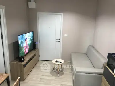 Modern living room with sleek furniture and wall-mounted TV, perfect for cozy relaxation.