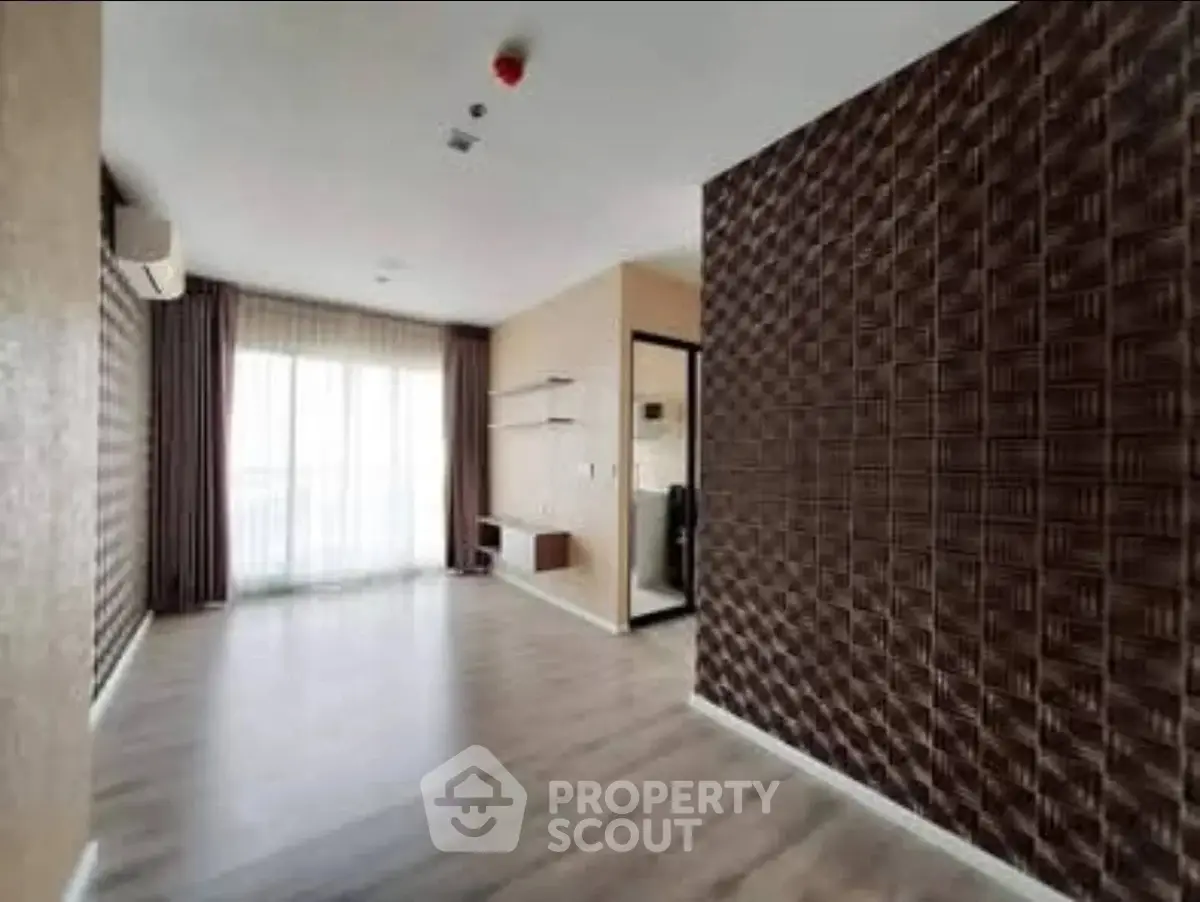 Spacious modern living room with textured accent wall and large windows