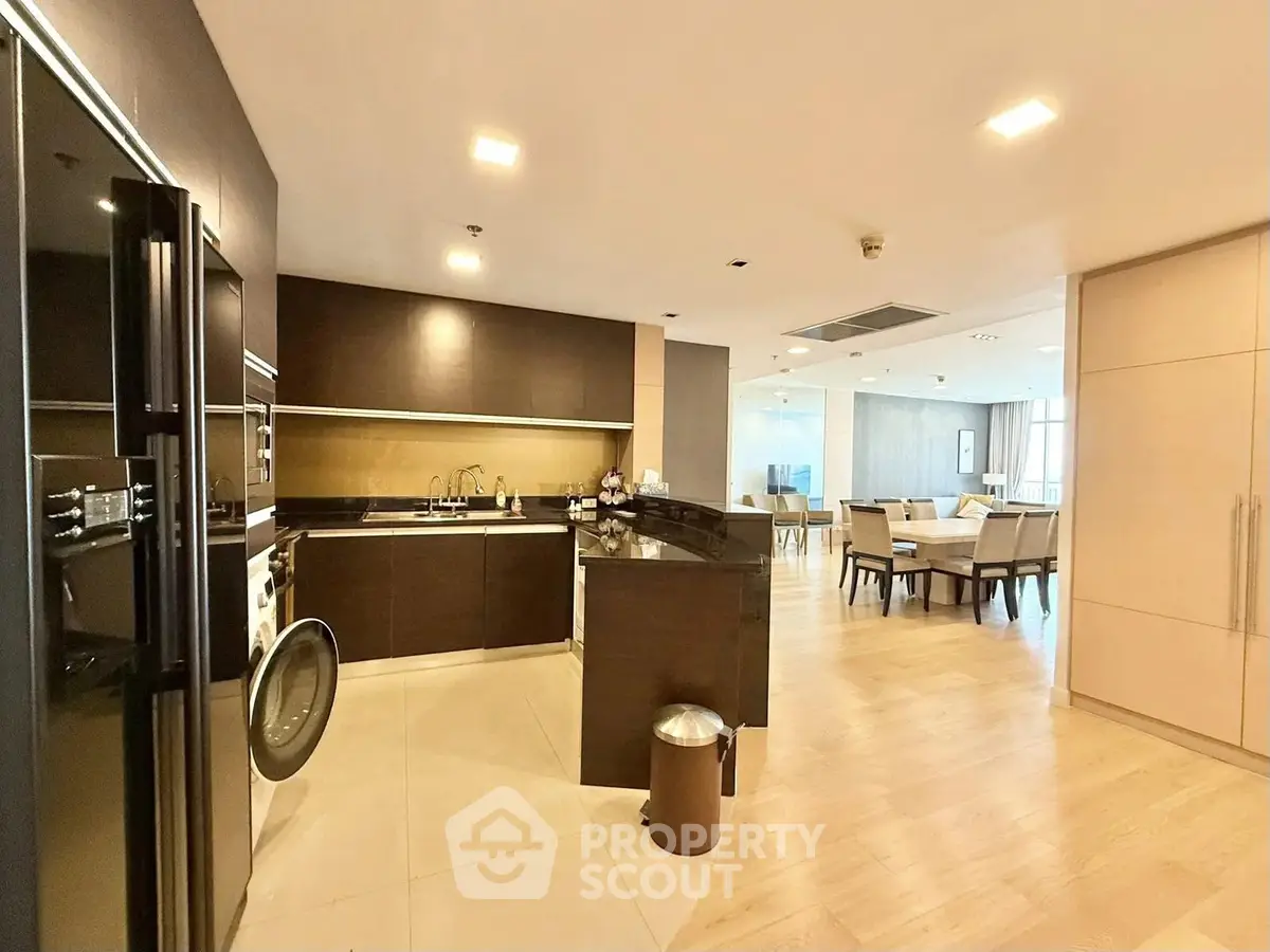 Spacious open-layout kitchen and dining area with modern appliances and elegant design.